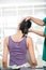 Chiropractor adjusting neck muscles to female