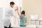 Chiropractor examining child with back pain