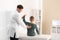 Chiropractor examining child with back pain