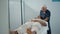 Chiropractor healing patient injury massaging head. Mature man examine problem