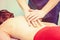 Chiropractor making treatment procedures. Young woman relaxing on massaging table, masseur working with her back. Beauty, health,