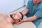 Chiropractor pressing on patient`s neck in clinic on rehabilitation therapy.