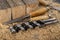 Chisels and wood drills laid on sawdust. Carpentry accessories in the workshop