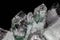 Chlorinated Quartz Crystals. Large crystals green and white; surrounded by clusters of smaller crystals.