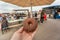Chocolat donut in hand of visitor of the street food market of Copenhagen, Denmark. Food of popular city market