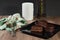 Chocolate alfajor on black plate on a wooden table and dark background