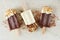 Chocolate and almond dipped popsicles, over marble