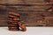 Chocolate aromatic cookies with pieces of cocoa stand in a stack on a background of wooden boards.