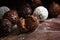 Chocolate, assortment of round truffle pralines on dark rustic w