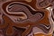 Chocolate background with liquify effect. Warm brown marble backdrop.