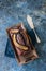 Chocolate banana date dread on a vintage tray on a blue stone ba