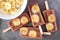 Chocolate banana popsicles on rustic grey background