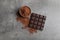 Chocolate bar and cocoa powder on grey background