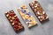 chocolate bars with various gourmet toppings on marble surface