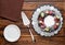 Chocolate berry cake on plate over brown wooden background