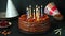 Chocolate birthday cake with candles. Party cake. Lighting candles. Make a wish. Happy birthday concept. Chocolate cake.