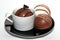 Chocolate bombs in mug with hot milk, filled with marshmallows and white chocolate on white background