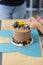 Chocolate brown cake with yellow toy decoration tractors party birthday cake close up still