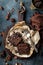 Chocolate brownie cake, dessert with nuts on dark background, directly above