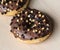 chocolate brownie donuts on table. The donuts is brown glazed with brownie parts