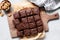 Chocolate brownie squares on cutting board, top view