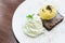 Chocolate brownie with vanilla ice-cream on the dish