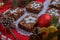 Chocolate brownies with icing sugar decorations together with Christmas decorations.