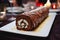 Chocolate Buche de Noel with Cream Swirls on Festive Table