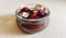 Chocolate budino with dryed raspberries and corn flakes in a glass jar