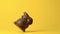 Chocolate bunny falling against yellow background