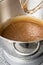 Chocolate cake batter in mixer bowl on kitchen table close up