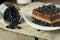 Chocolate cake with blueberry and glass with berries