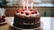 Chocolate cake with cherries and candles with fire