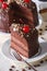 Chocolate cake with cherry and a piece. Vertical