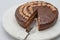 Chocolate cake with chocolate cream and chocolate ganache close up on marble serving board