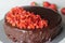Chocolate cake with chocolate ganache and topped with fresh strawberries for a valentines day date