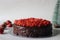 Chocolate cake with chocolate ganache and topped with fresh strawberries for a valentines day date