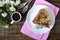 Chocolate cake with nut cream on a wooden table. A piece of cake on a plate and a cup of coffee. The top view