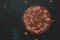 Chocolate cake with nuts, black background, top view