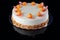 Chocolate cake with physalis fruits, cream, nuts and mousse over black background