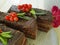 Chocolate cake, red currant, mint, flower portion creamy biscuit flavor summer plate on white wooden