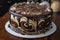 chocolate cake with rich ganache filling, surrounded by swirls of dark and white chocolate