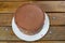 Chocolate cake with semisweet chocolate ganache frosting. On the wooden table_top view