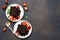 Chocolate cake slices on the plate on a concrete dark background. View from above. Brownie pie