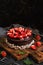 Chocolate cake with strawberries. Dark food photography. Rustic style, selective focus.