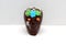 Chocolate candy in the shape of a traditional skull from the altar with bread of the dead, cempasuhil and candle for the Day of th