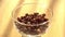Chocolate cereals falling in a bowl. A healthy breakfast poured in glass along sunrise. Making cereals chocolate