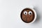 Chocolate chip cookie character floats in Cup of tea. Coffee Cup with cookies on white background. Top view