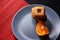 Chocolate chip cookies and piece of orange on plate and on red and black background with place for text selective focus with copys