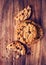 Chocolate chip cookies pile shot on wooden table, top view. Choc